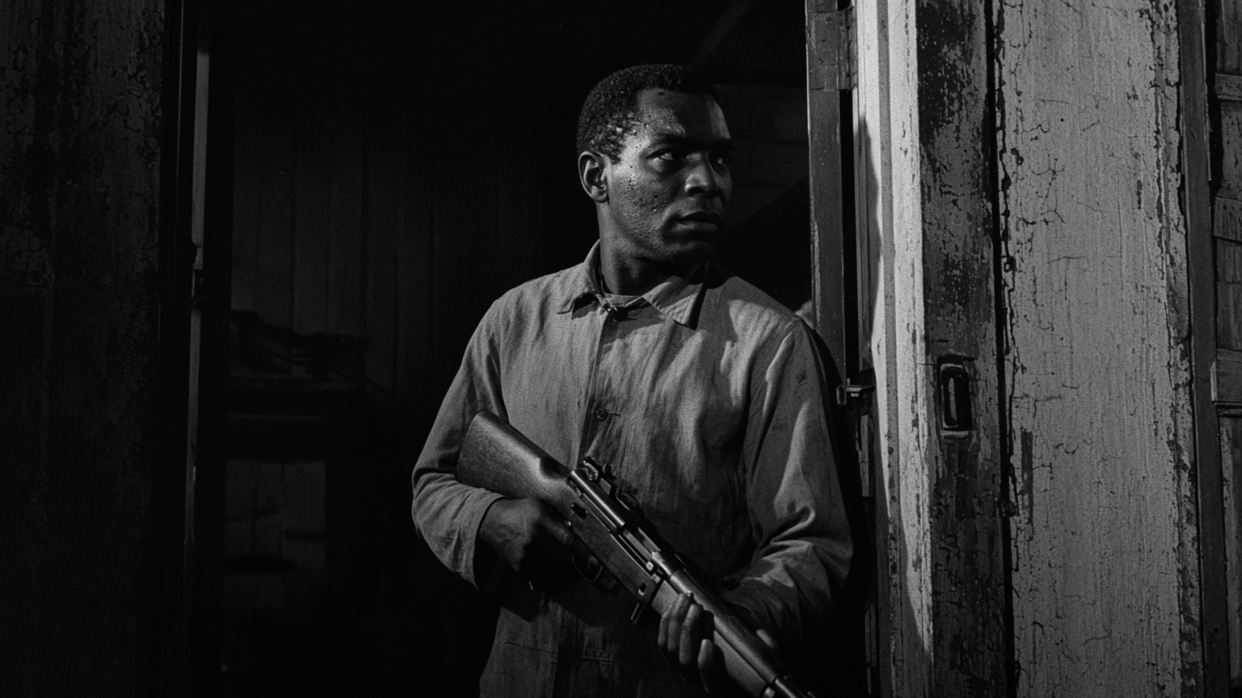 A man with a rifle stands in a dark doorway.