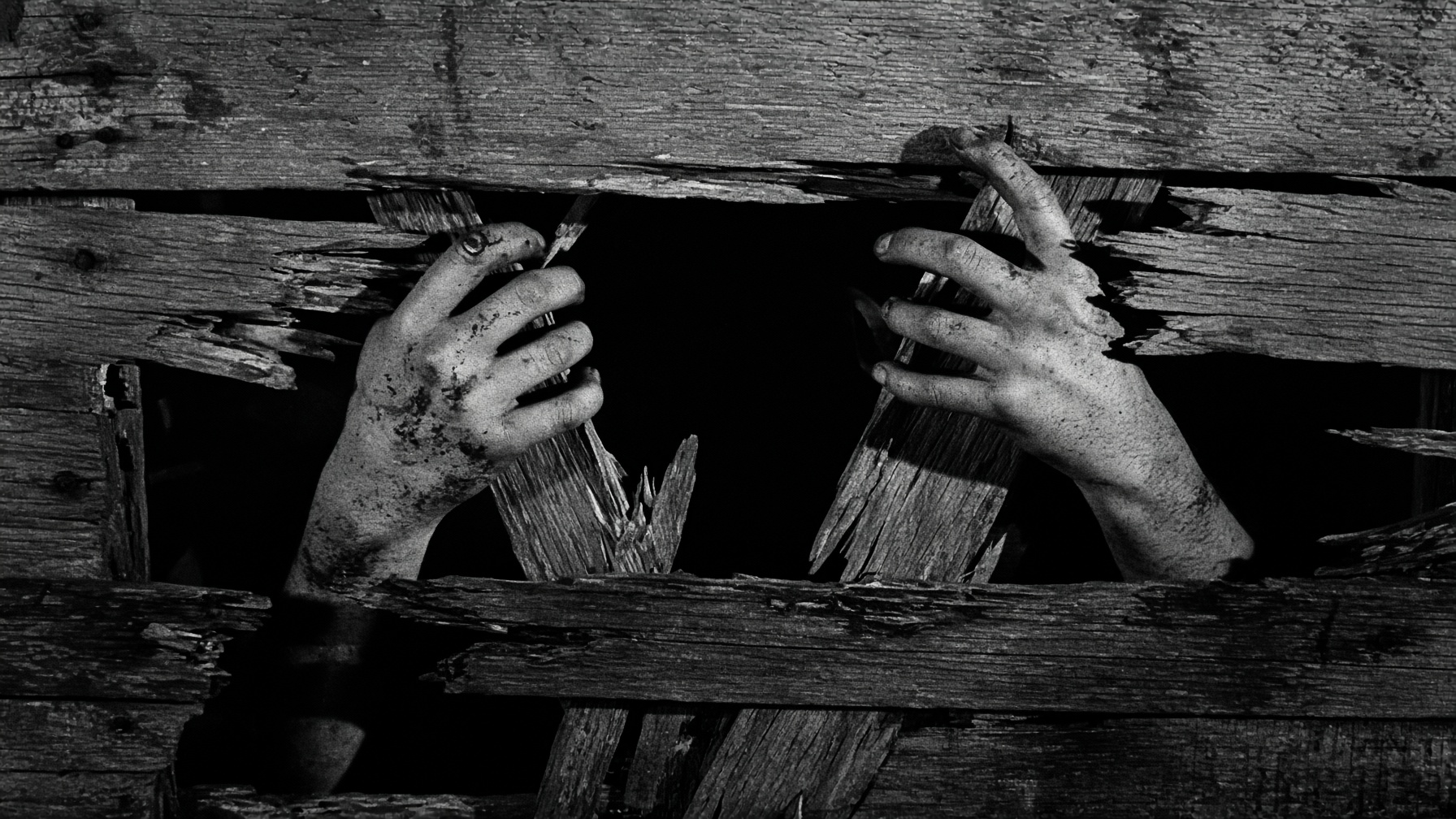 Hands forcing through broken boards.